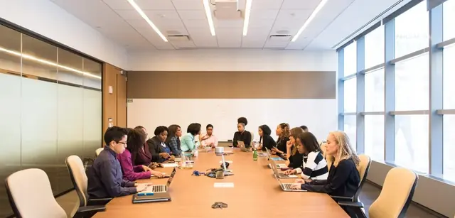 People having a meeting at a large table